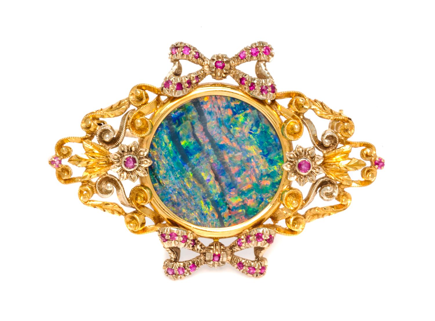 An 18 Karat Bicolor Gold, Opal Doublet and Ruby Brooch, 7.60 dwts.