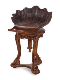 An Italian Carved Walnut Shell-Form Piano Stool