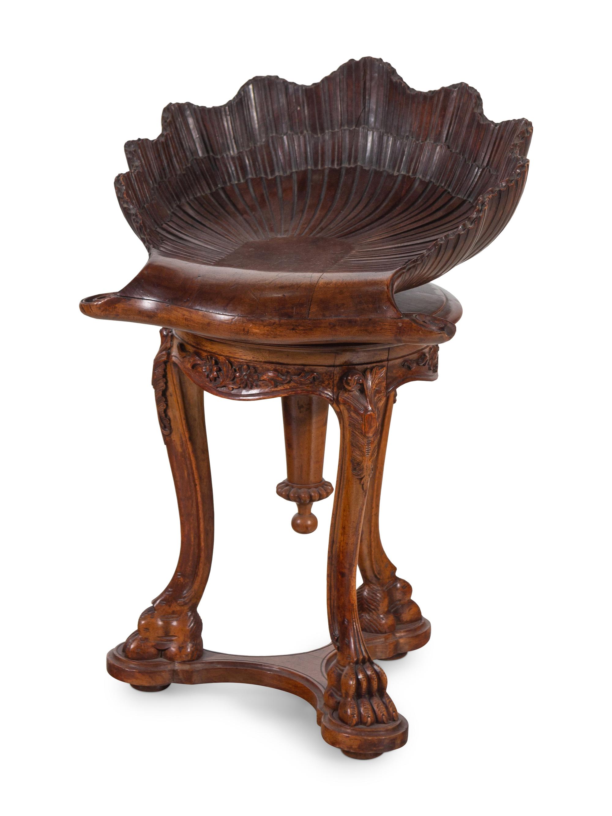 An Italian Carved Walnut Shell-Form Piano Stool