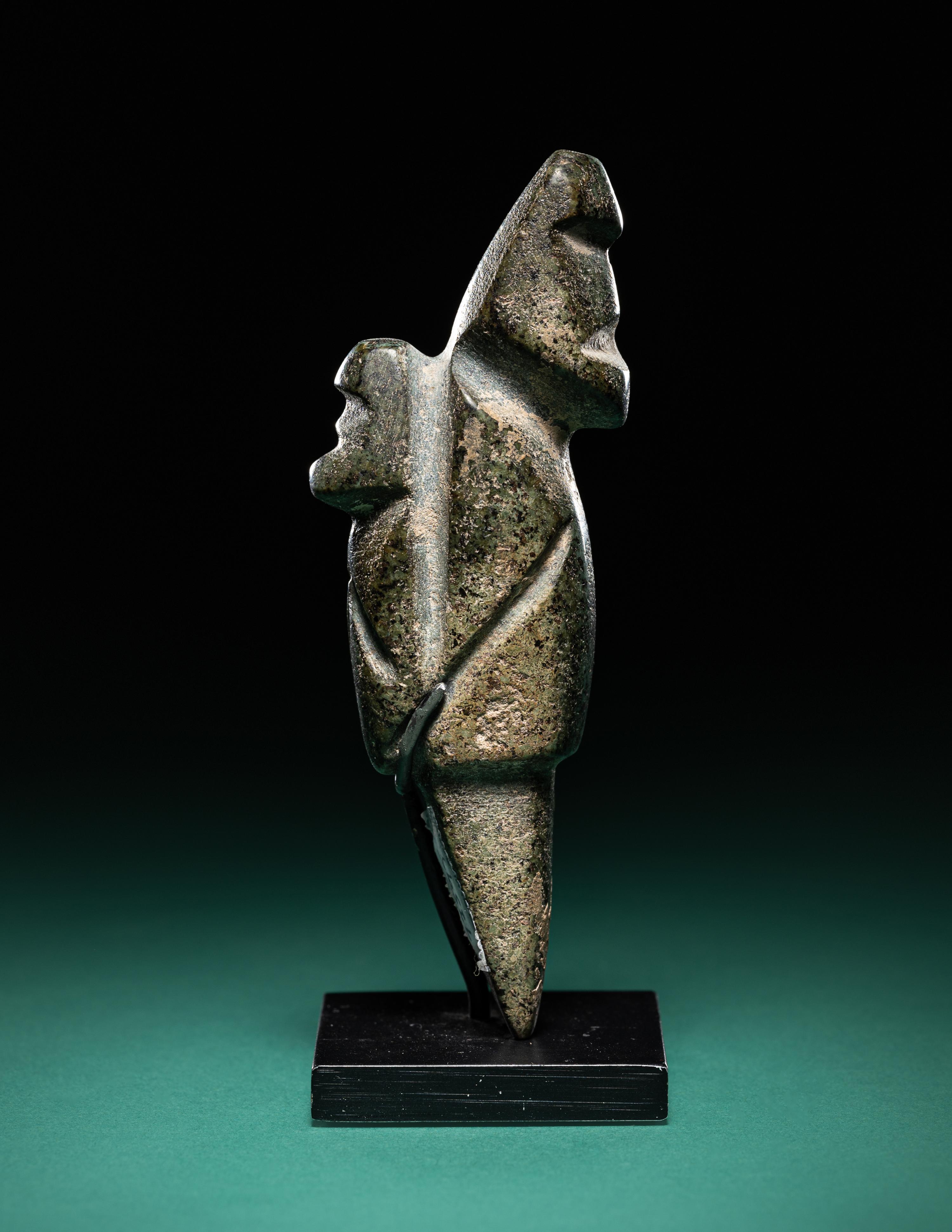 A Mezcala Diorite Standing Figure with an Infant