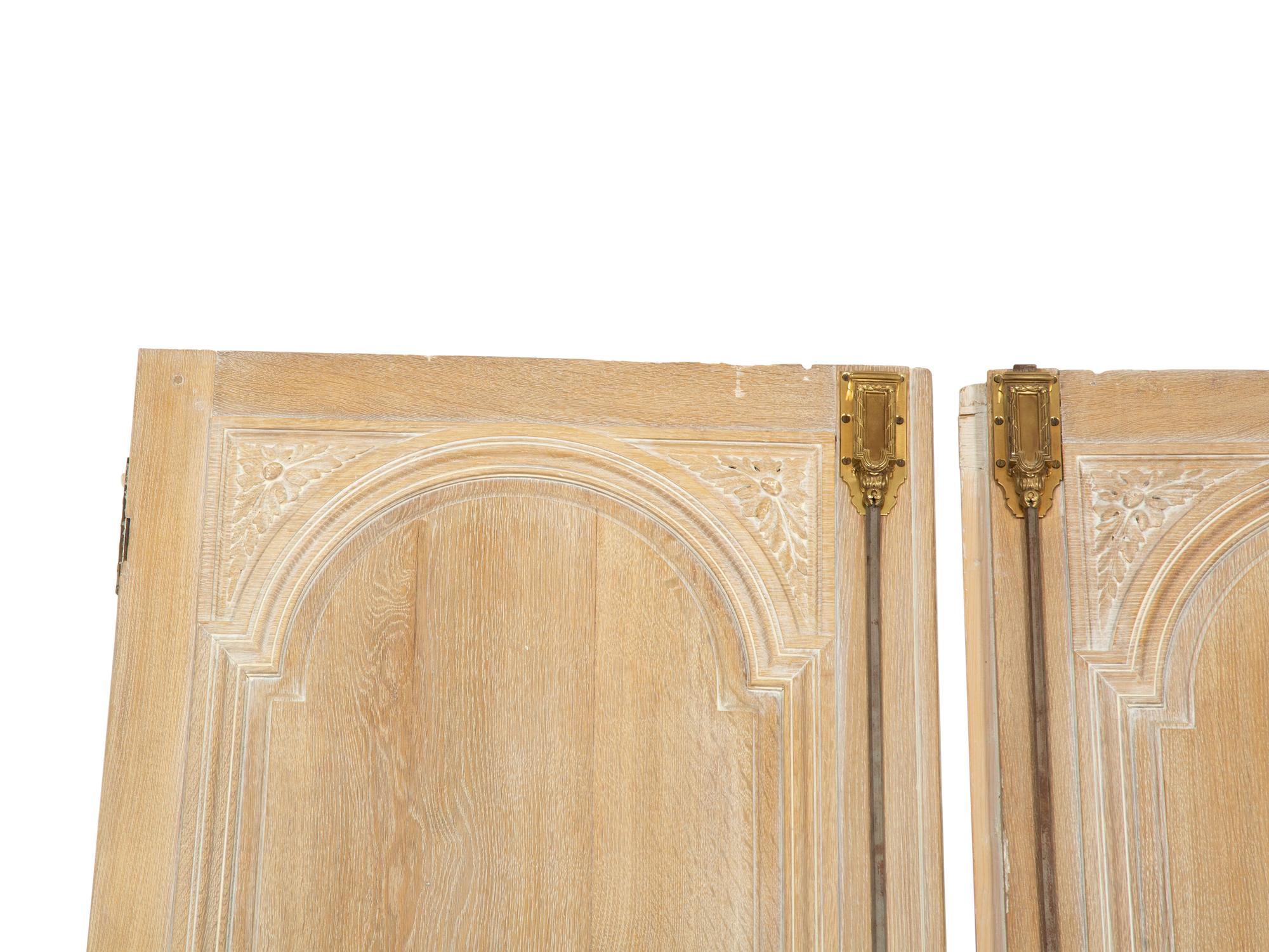A Pair of French Cerused Oak Doors with Gilt Bronze Fixtures