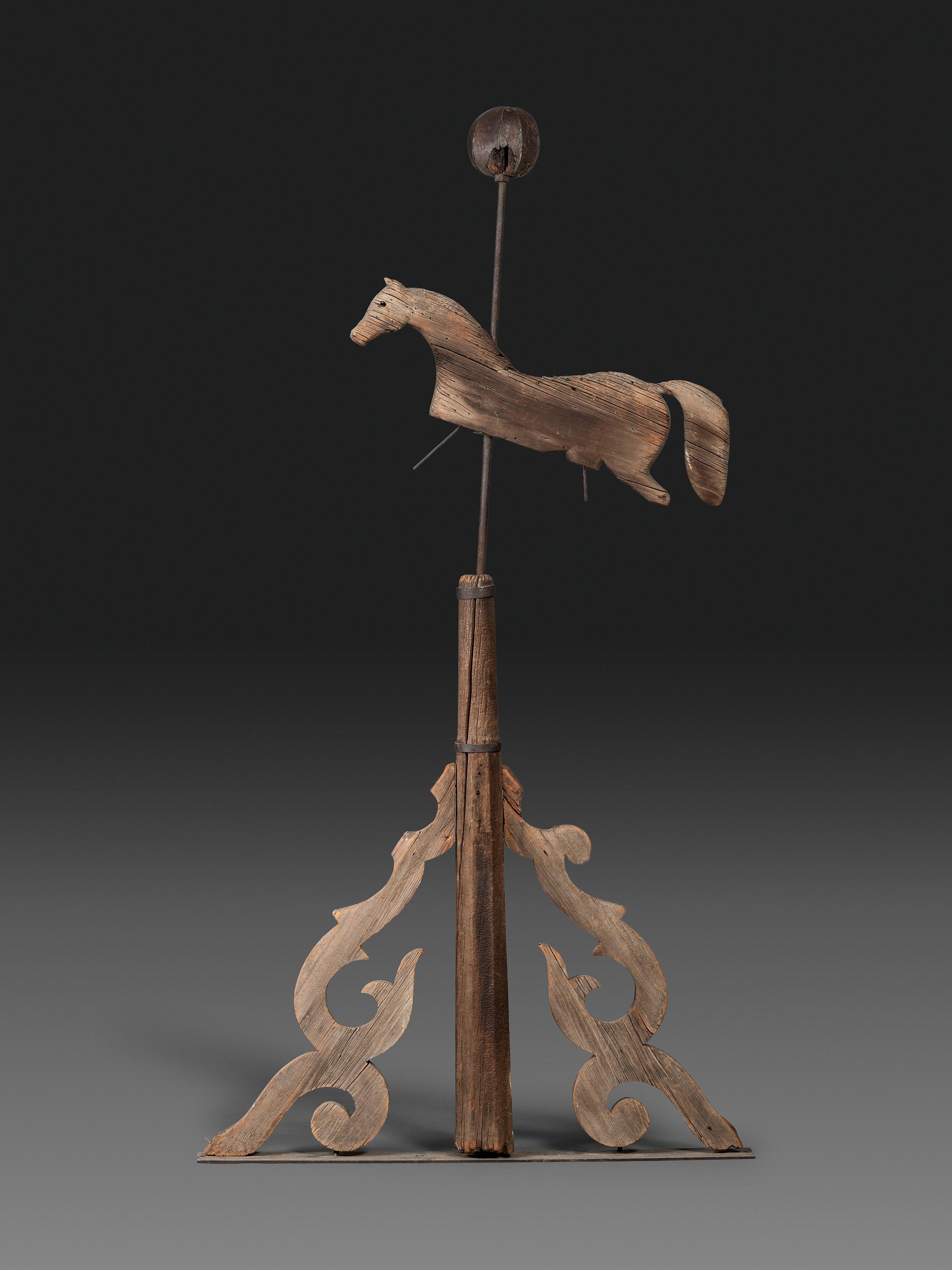 A Primitive Carved Pine and Cast Iron Horse Weathervane on Stand