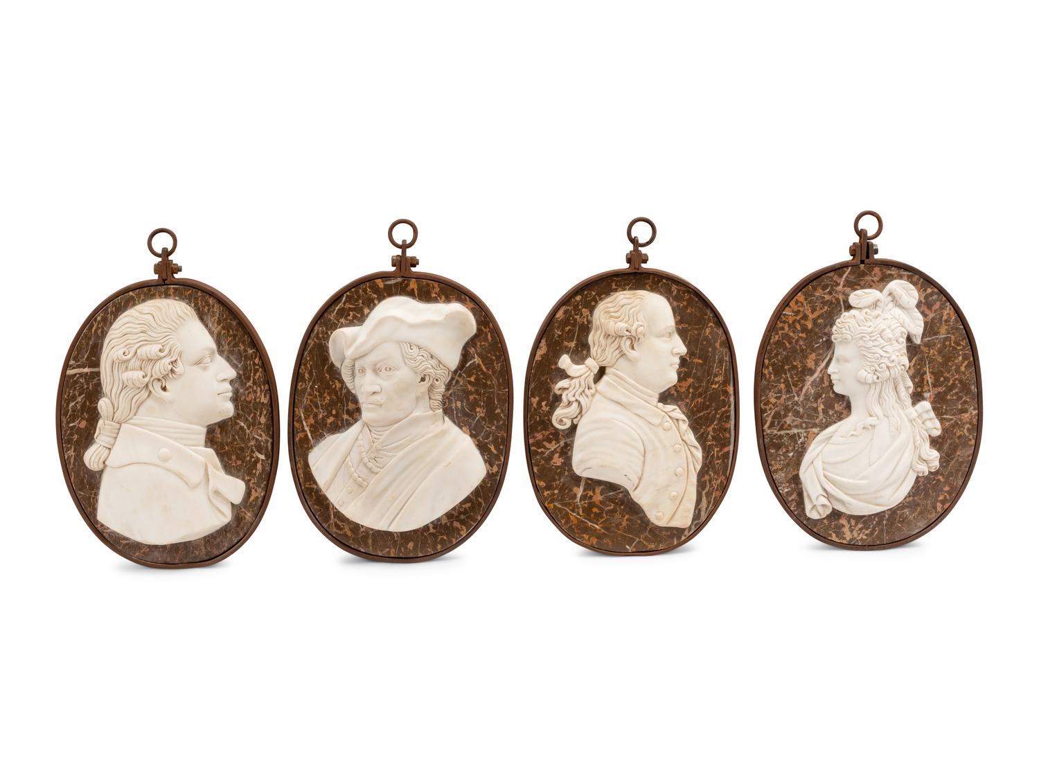 A Set of Four Iron-Framed Carved Marble Portrait Plaques of English Figures