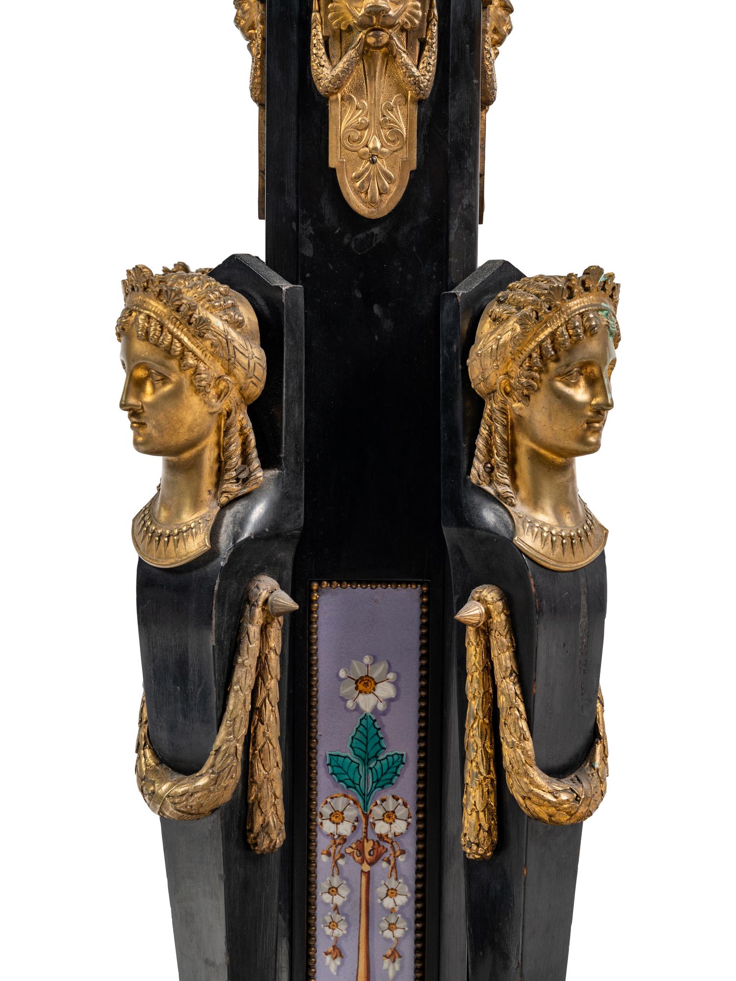 A Pair of Egyptian Revival Gilt Bronze and Porcelain Mounted Ebonized Pedestals