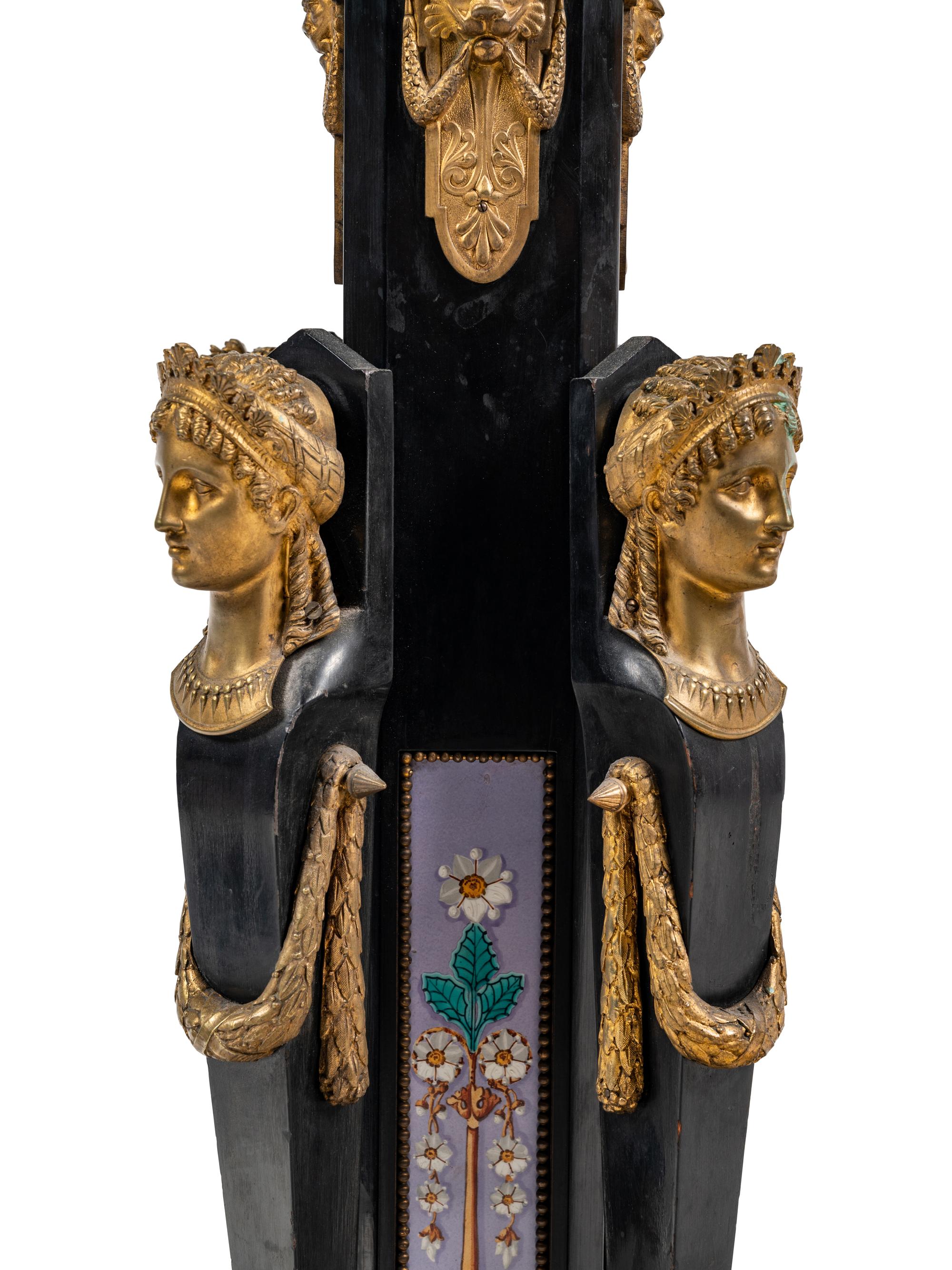 A Pair of Egyptian Revival Gilt Bronze and Porcelain Mounted Ebonized Pedestals