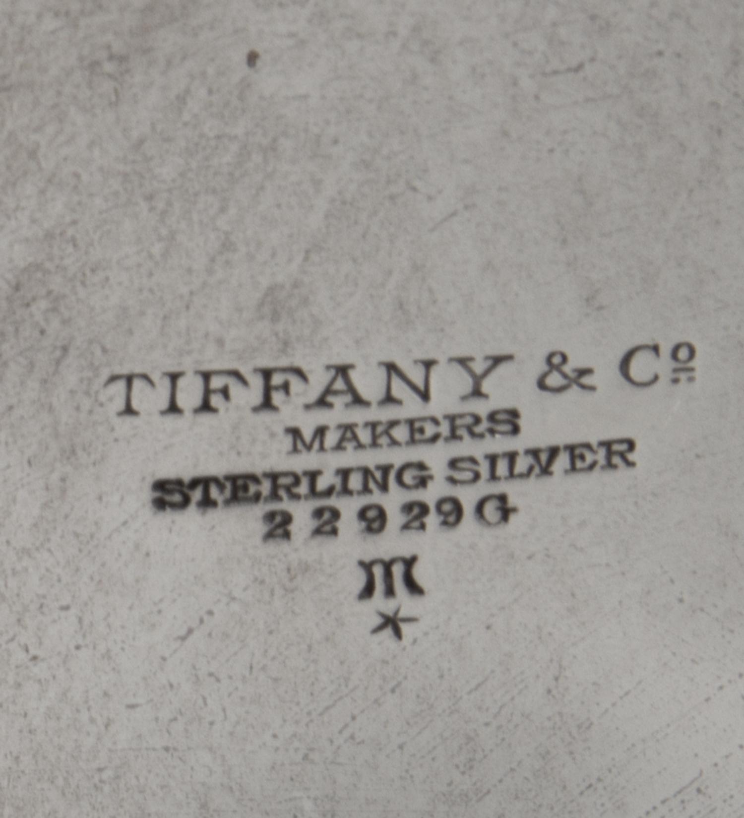 An American Silver Dish, Tiffany & Co., New York, NY, First half 20th century, having scalloped edges with foliate and berry engraving.