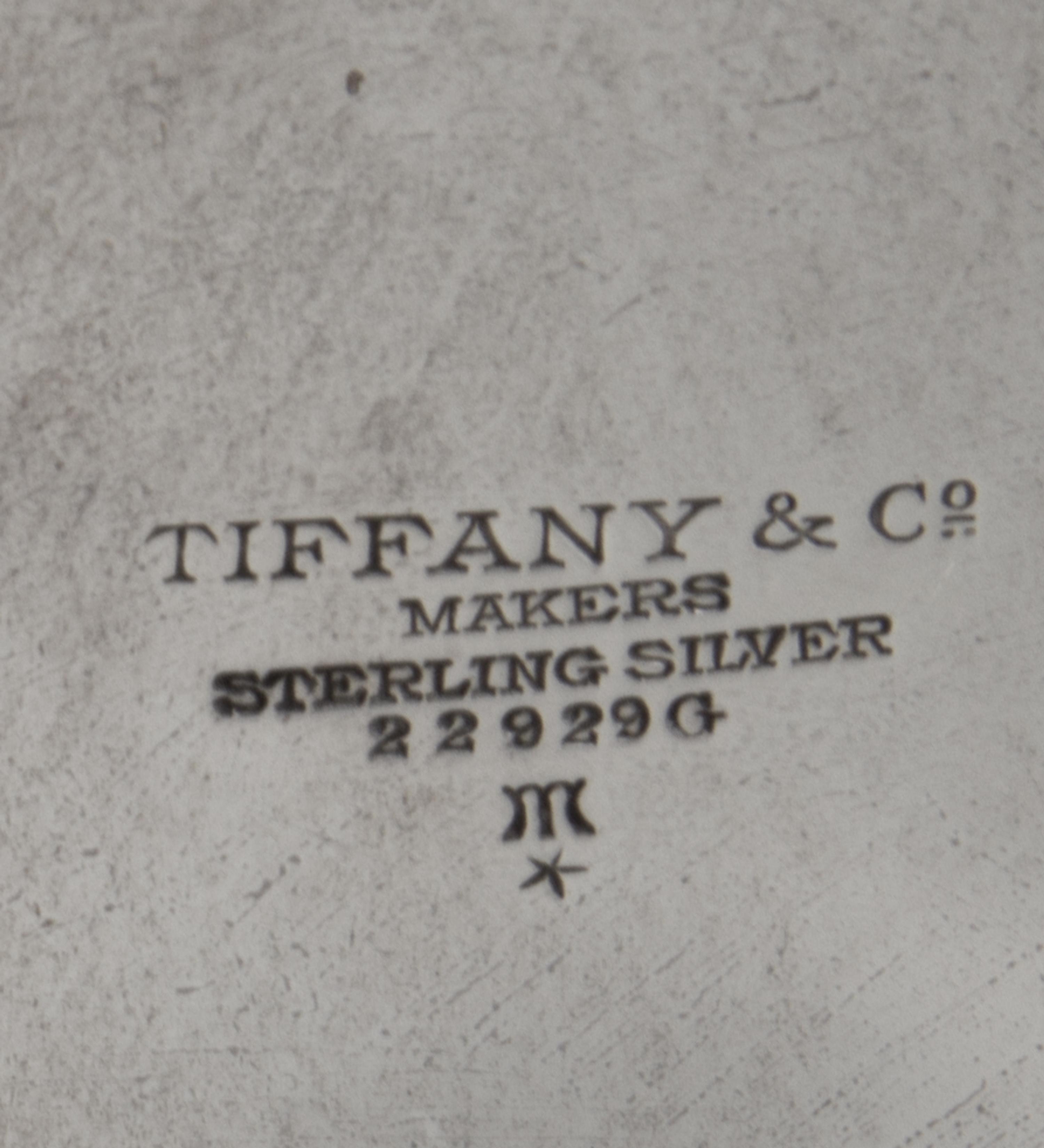 An American Silver Dish, Tiffany & Co., New York, NY, First half 20th century, having scalloped edges with foliate and berry engraving.