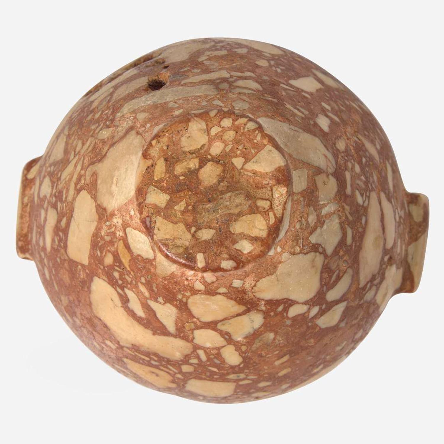 An Egyptian red breccia jar Predynastic Period (Naqada II), circa 3500-2900 B.C.