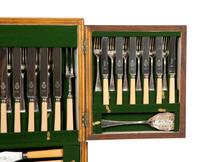 An Extensive Silver-Plate Flatware and Tea Service in a Fitted Wooden Case on Mahogany Stand