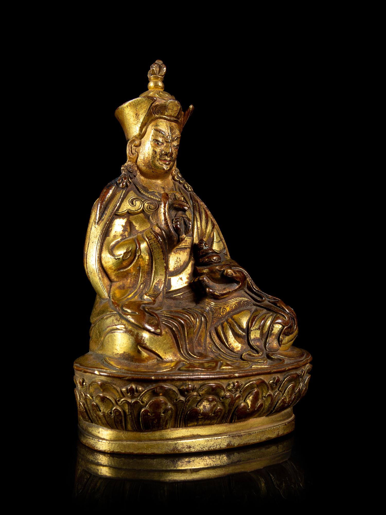 A Small Sino-Tibetan Gilt Bronze Figure of Penchen Lama