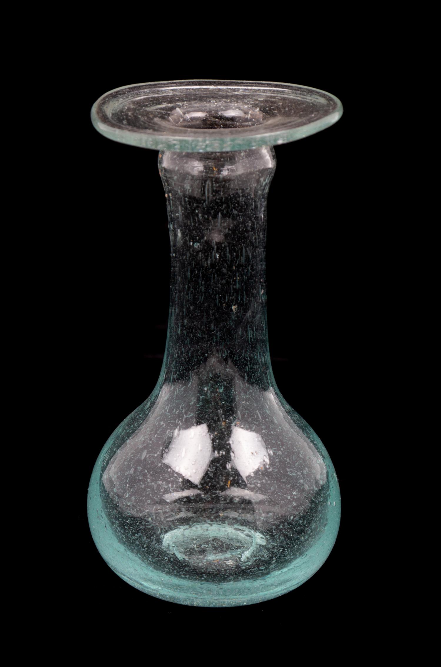 A Roman Glass Unguentarium Height 4 1/2 inches. — CIRCA 1ST-2ND CENTURY C.E.