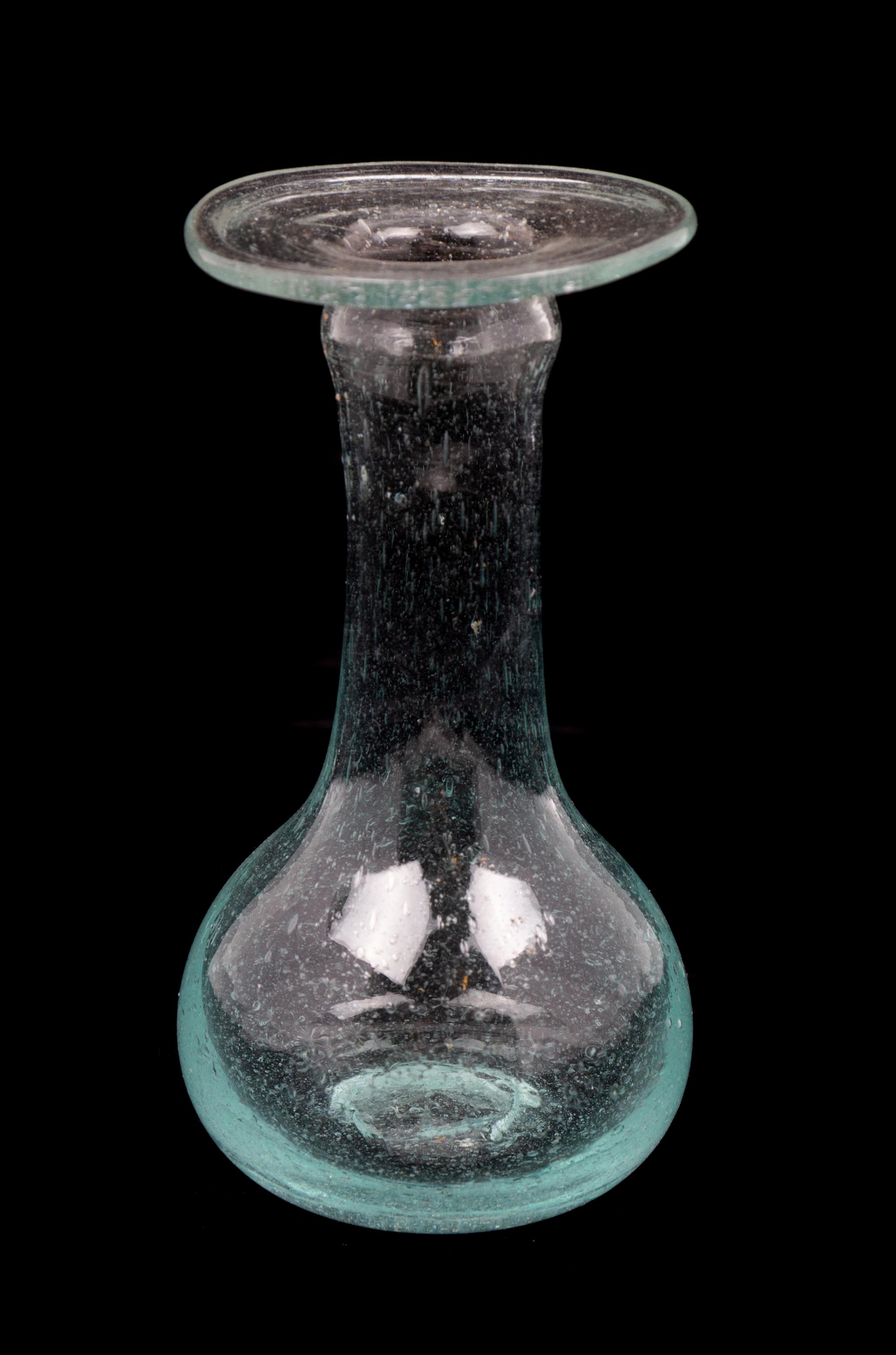 A Roman Glass Unguentarium Height 4 1/2 inches. — CIRCA 1ST-2ND CENTURY C.E.