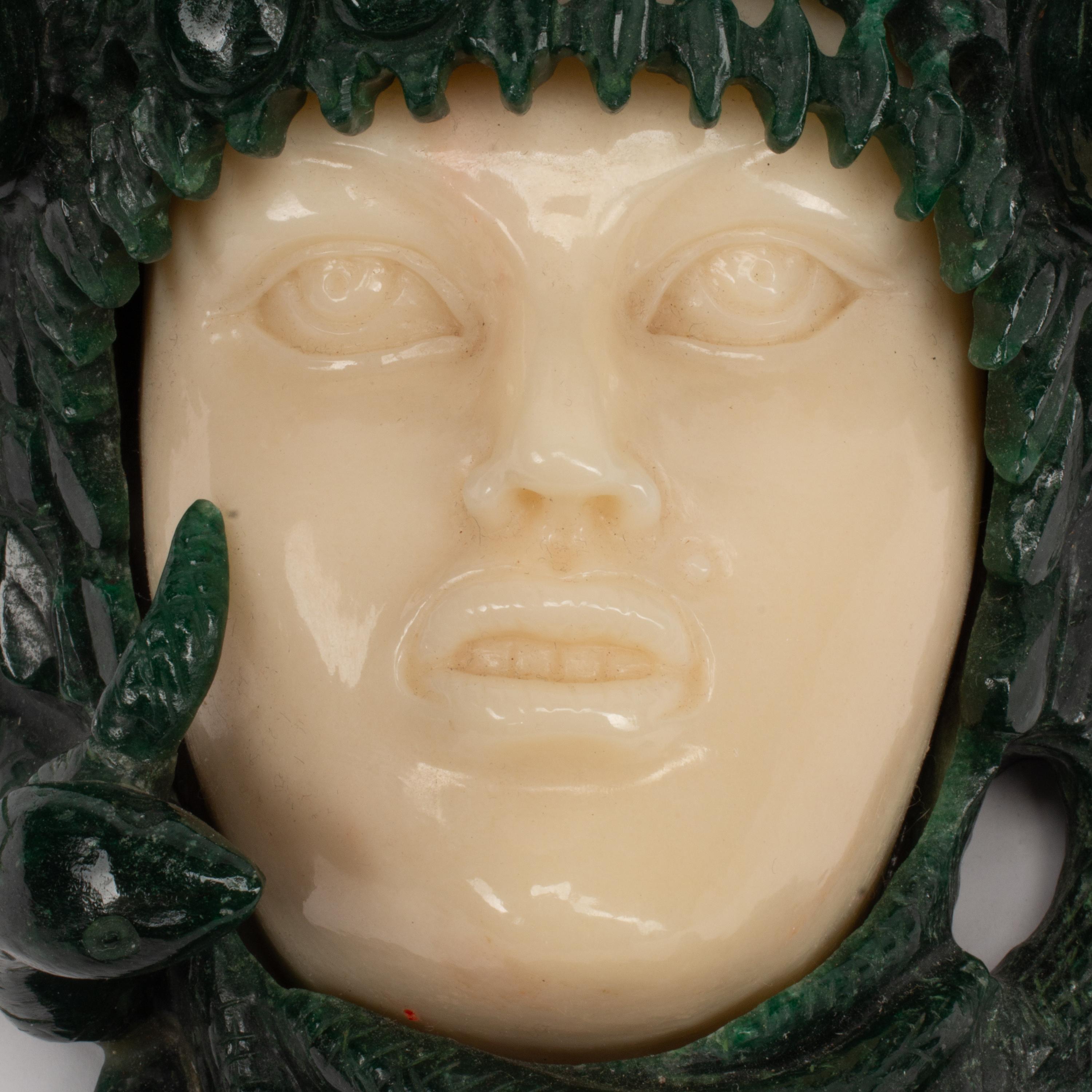 A Carved Green and Yellow Aventurine Medusa Wall Ornament