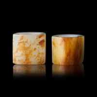 Two Chinese Russet and White Jade Archer's Rings, 18th/19th Century 清中期 白玉灑金皮扳指兩枚