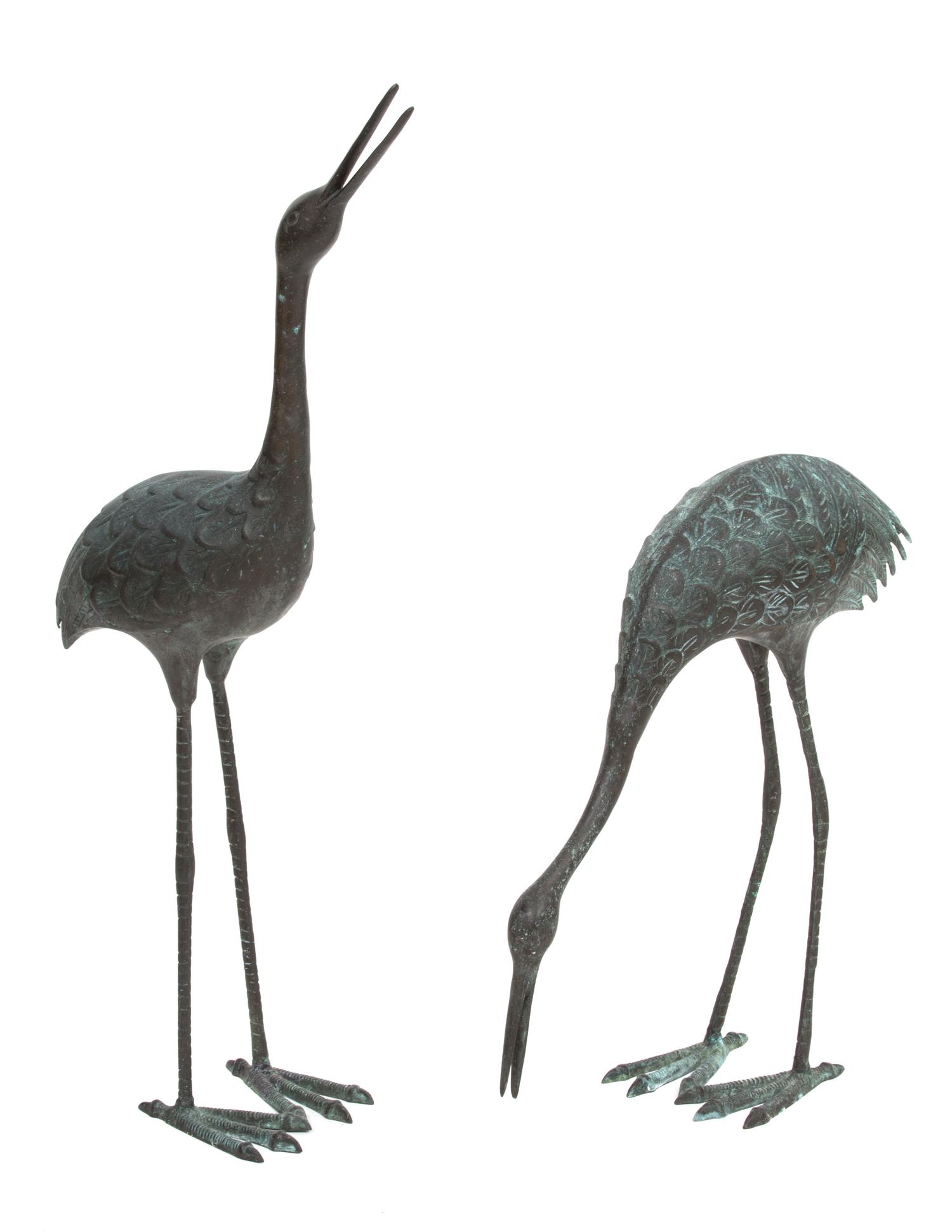 A Pair of Patinated Metal Standing Cranes Height of taller 38 1/2 inches. — 20TH CENTURY