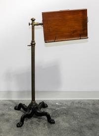 A Wood and Metal Book Stand Height 37 inches.