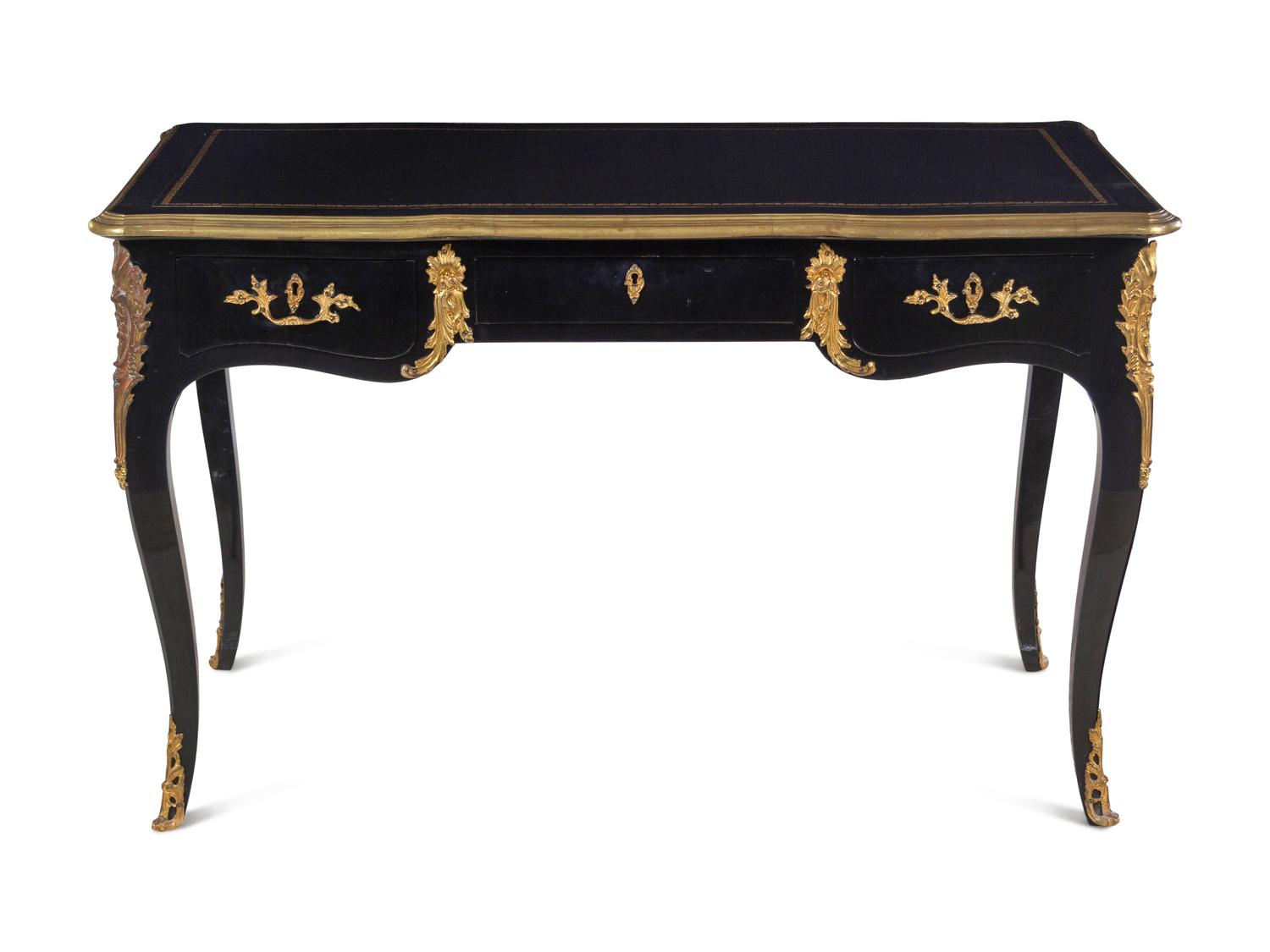 A Louis XV Style Gilt Metal Mounted Ebonized Bureau Plat