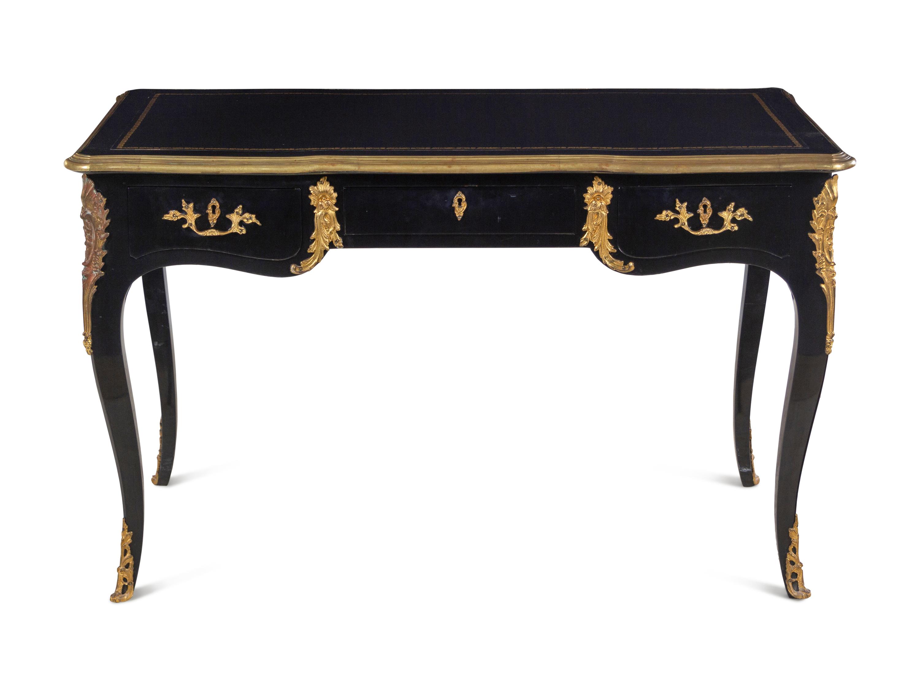 A Louis XV Style Gilt Metal Mounted Ebonized Bureau Plat