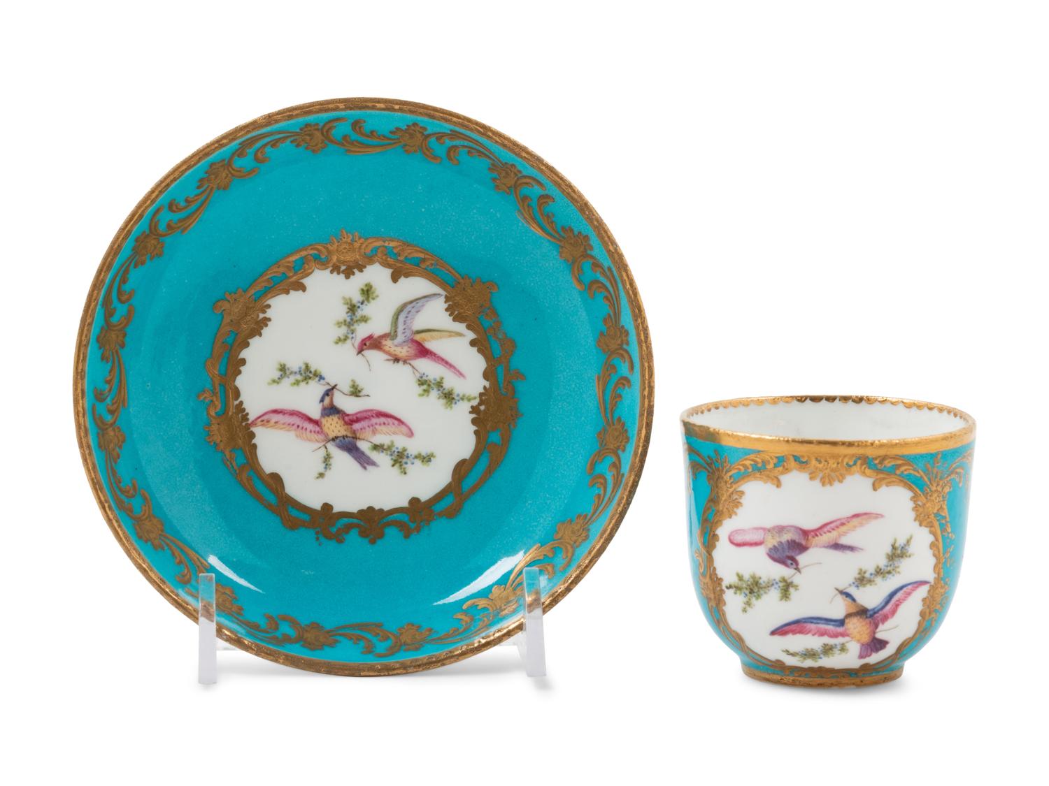 A Sèvres Painted and Parcel Gilt Porcelain Tea and Cordial Service in a Fitted Kingwood and Parquetry Traveling Case