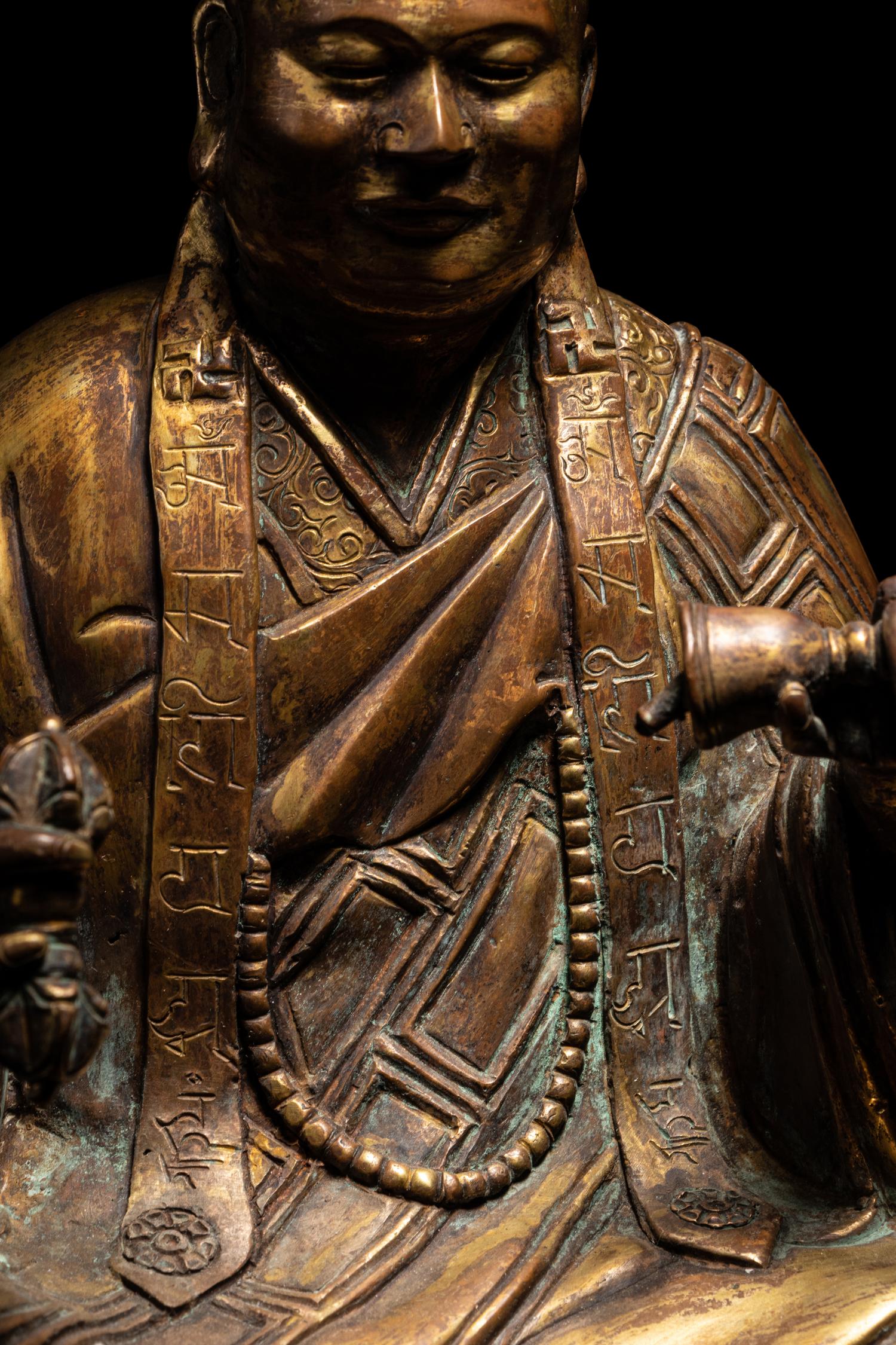 A Tibetan Gilt Bronze Figure of a Seated Guru