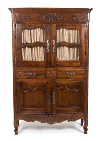 A French Provincial Carved Fruitwood Buffet a Deux Corps Height 79 1/2 x width 50 3/4 x depth 21 1/2 inches. — 19TH CENTURY