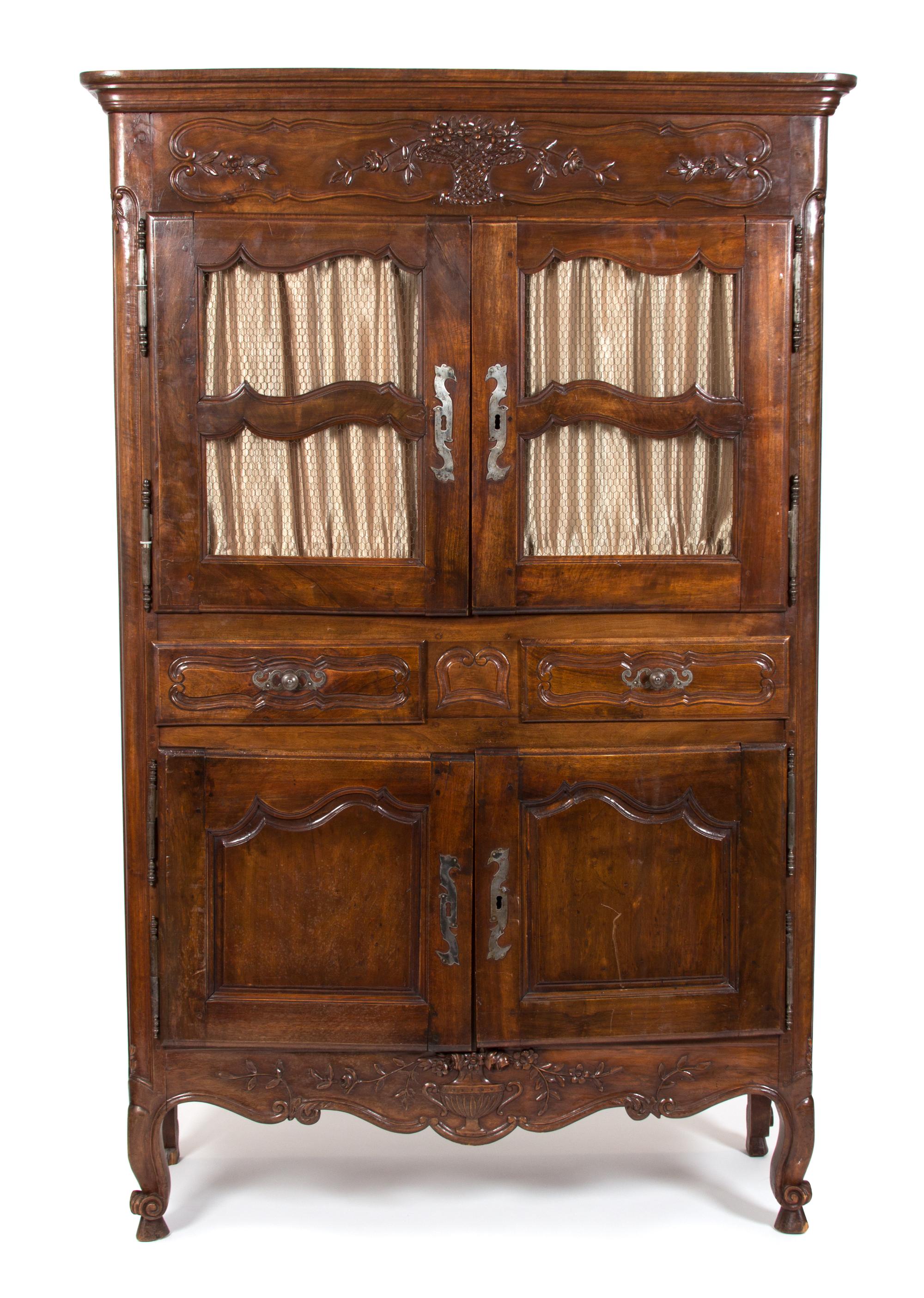 A French Provincial Carved Fruitwood Buffet a Deux Corps Height 79 1/2 x width 50 3/4 x depth 21 1/2 inches. — 19TH CENTURY