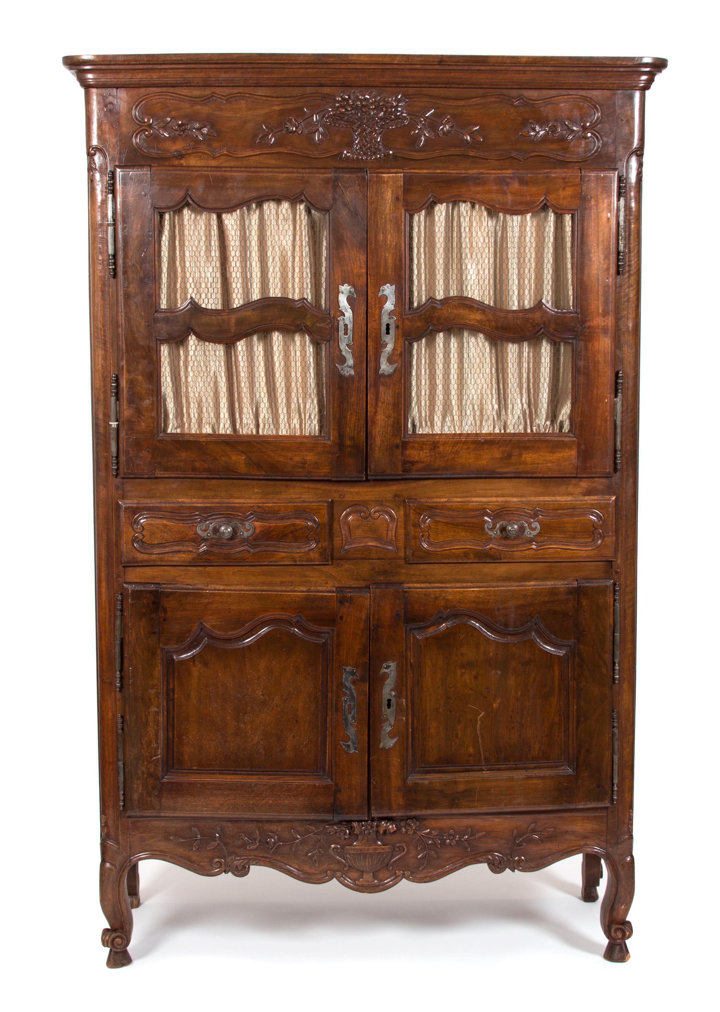 A French Provincial Carved Fruitwood Buffet a Deux Corps Height 79 1/2 x width 50 3/4 x depth 21 1/2 inches. — 19TH CENTURY