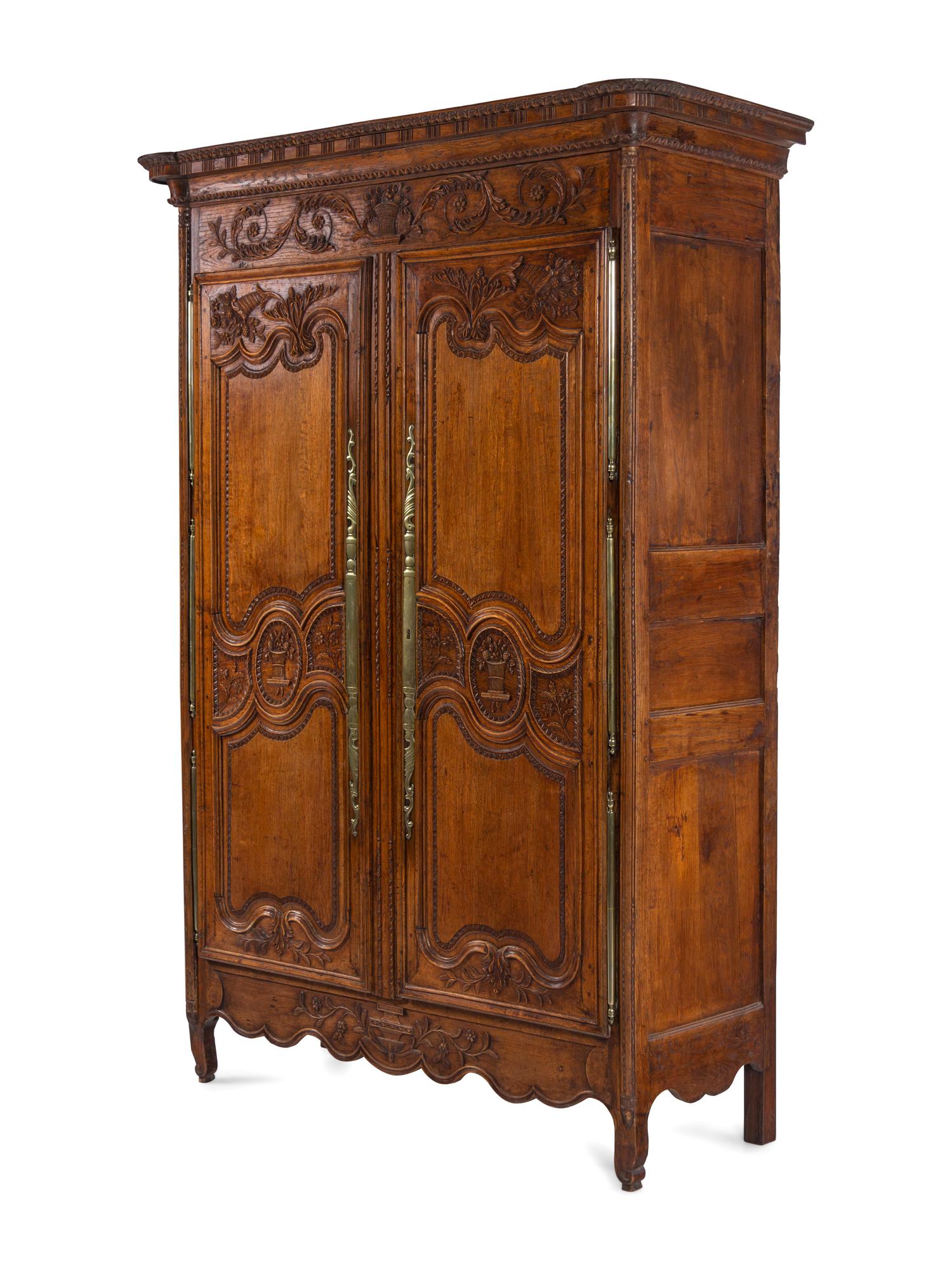 A Louis XV Provincial Brass Mounted Carved Oak Armoire