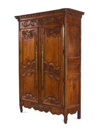A Louis XV Provincial Brass Mounted Carved Oak Armoire