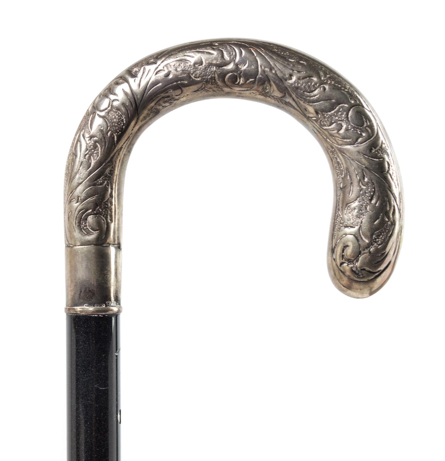 A Continental Silver Handled Ebonized Cane. Length 35 1/2 inches.