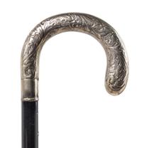 A Continental Silver Handled Ebonized Cane. Length 35 1/2 inches.