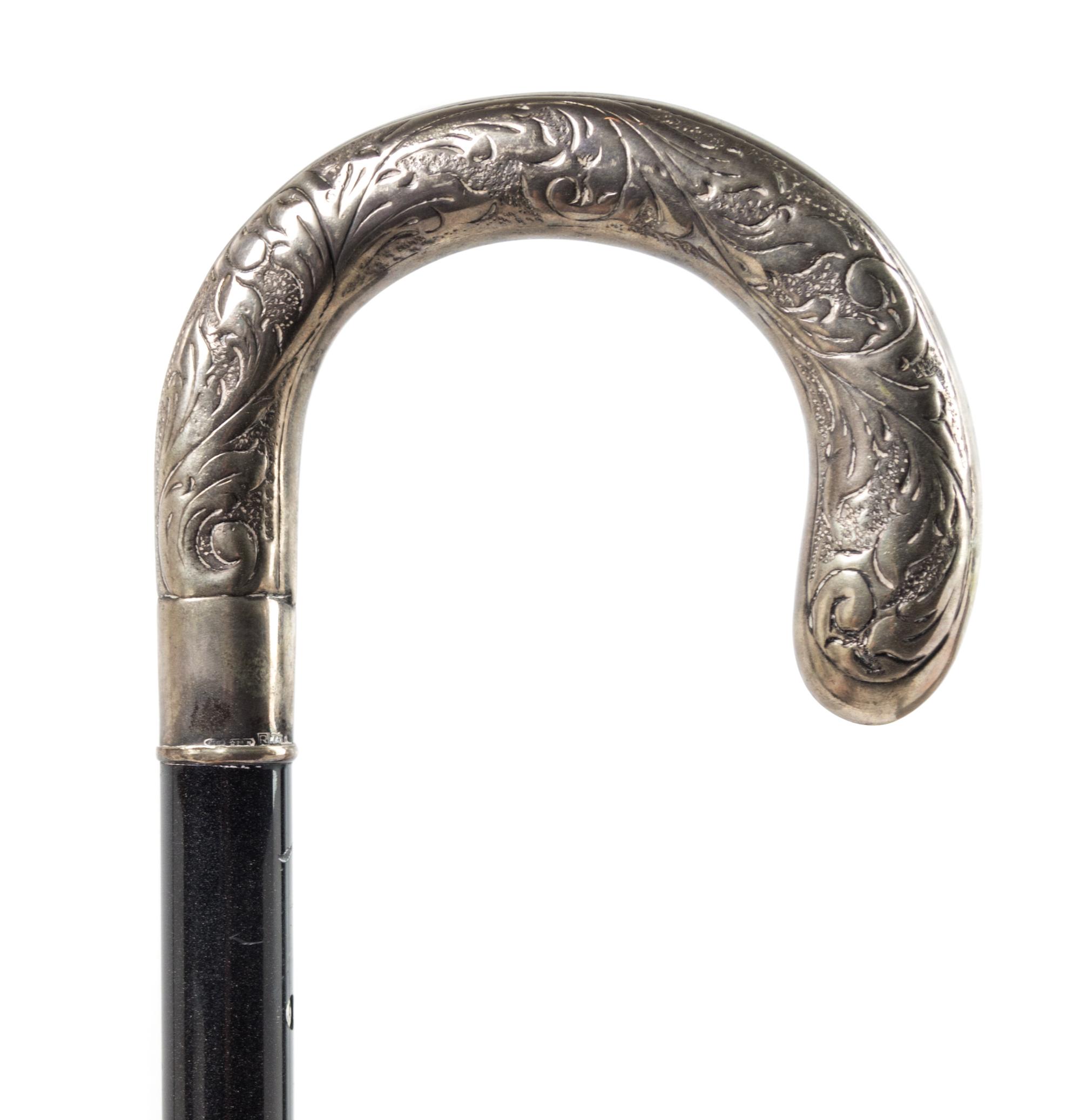 A Continental Silver Handled Ebonized Cane. Length 35 1/2 inches.
