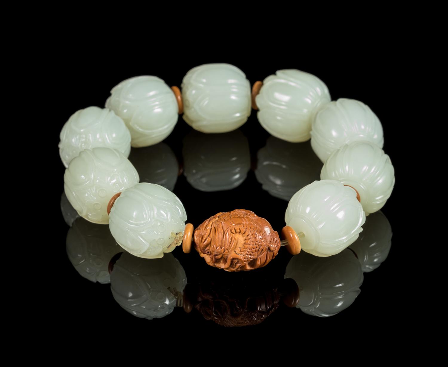A White Jade Lotus-Shaped Bead Bracelet Diameter of bead 3/4 inches. — 20TH CENTURY