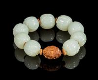 A White Jade Lotus-Shaped Bead Bracelet Diameter of bead 3/4 inches. — 20TH CENTURY
