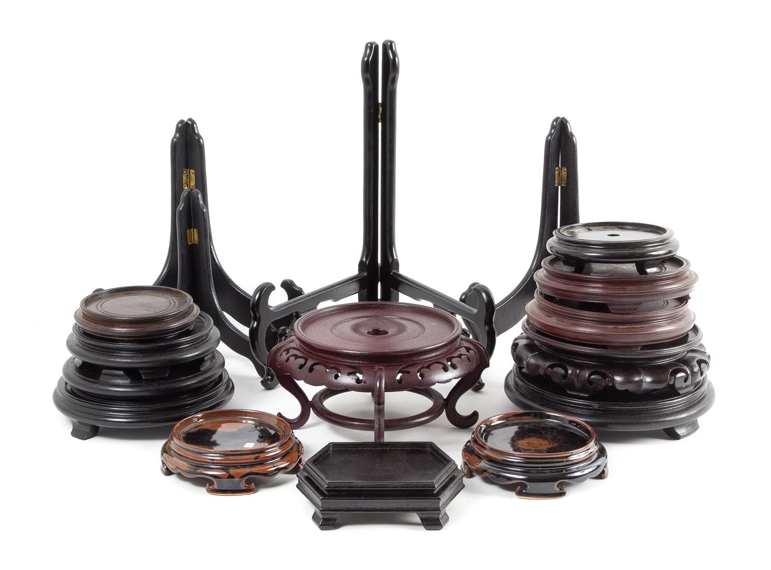 Twenty-Four Chinese Wood and Porcelain Stands Height of tallest 18 3/4 inches.