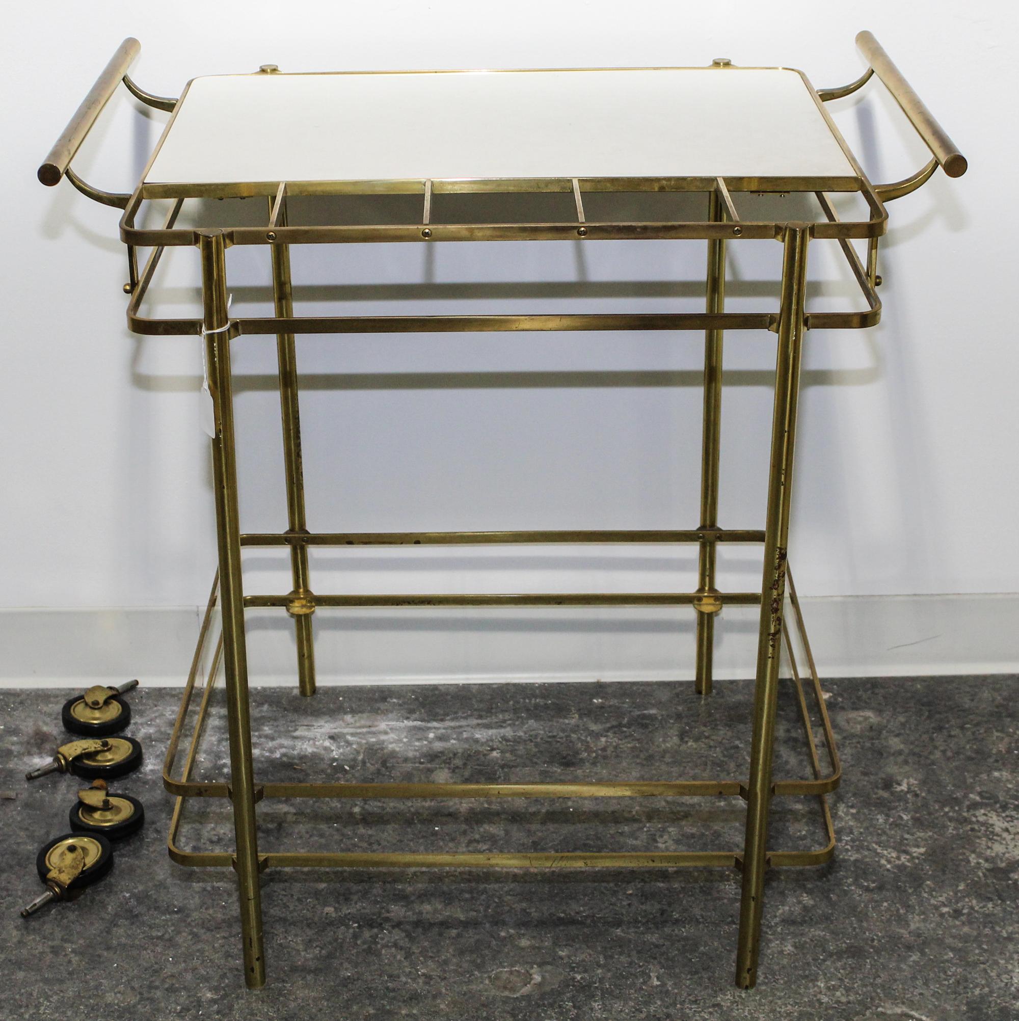 An Italian Brass and Glass Bar Cart. Height 34 inches.