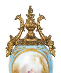 A Pair of Sèvres Style Porcelain Small Urns with Gilt Metal Mounts