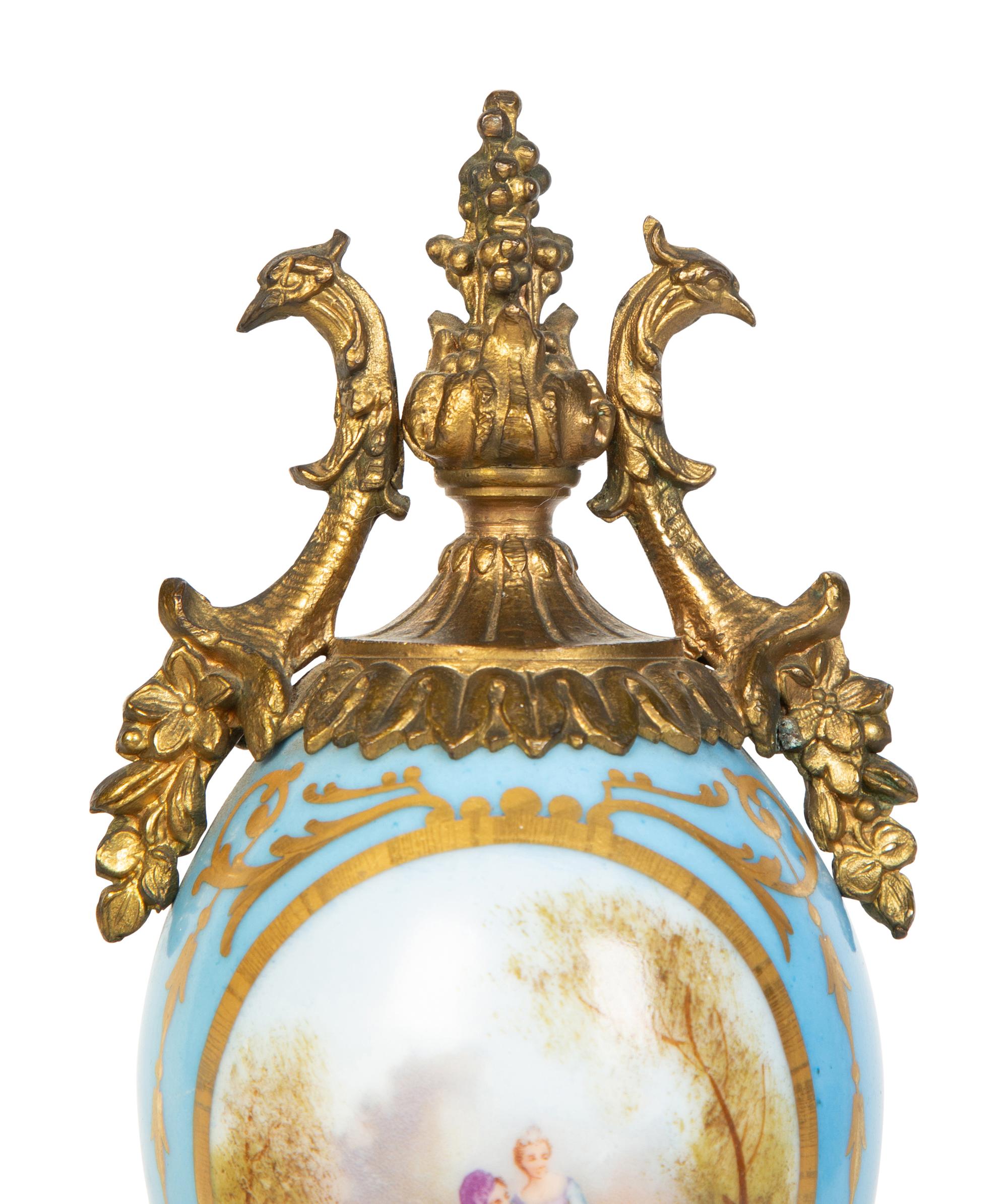 A Pair of Sèvres Style Porcelain Small Urns with Gilt Metal Mounts