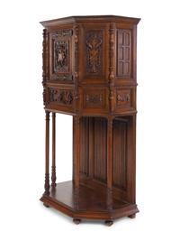 A Gothic Revival Carved Oak Cabinet on Stand