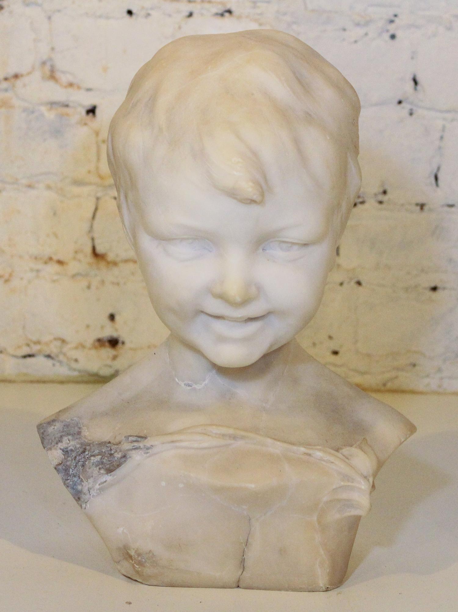 A Carved Marble Bust. Height 13 inches.