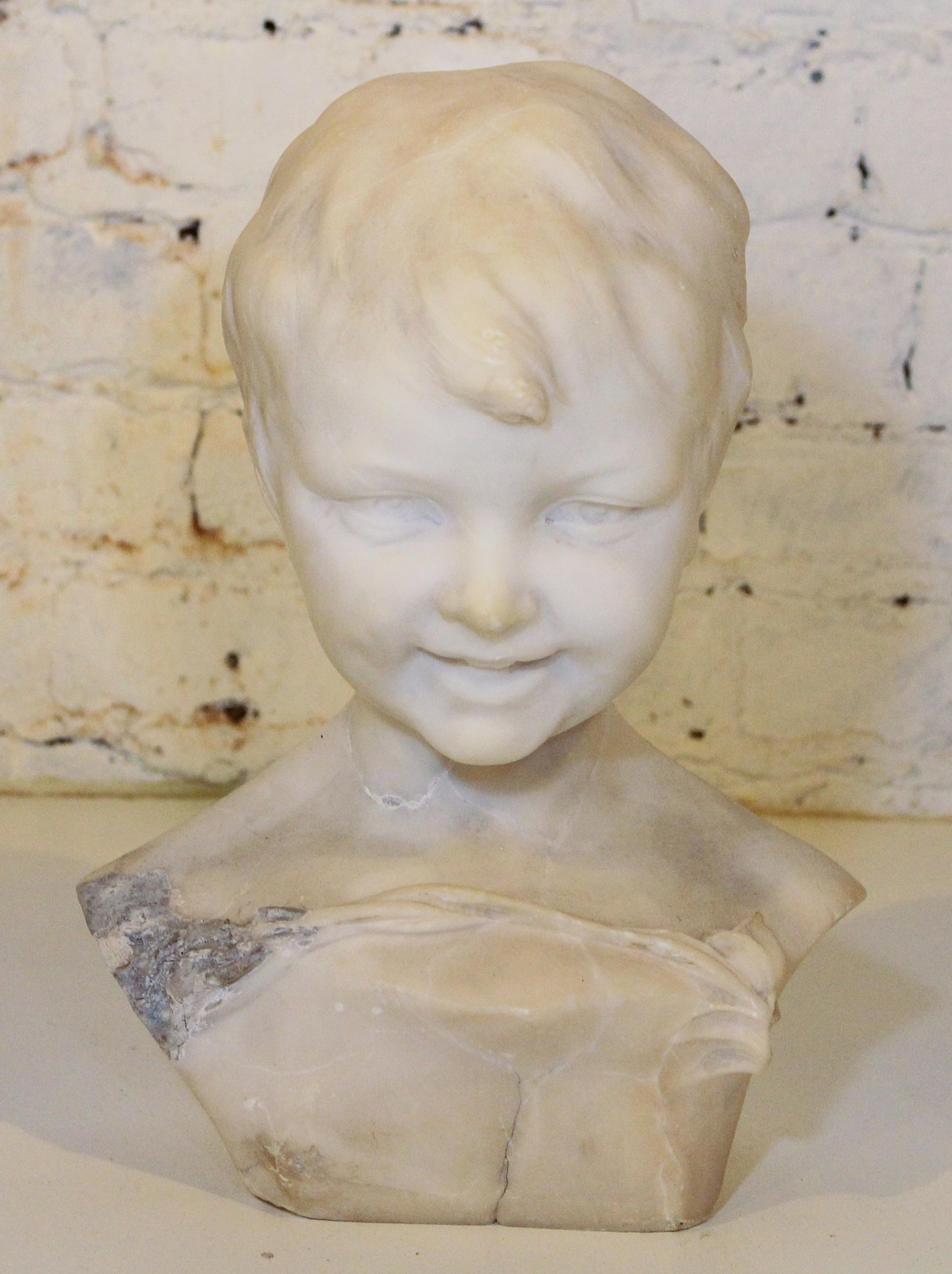 A Carved Marble Bust. Height 13 inches.