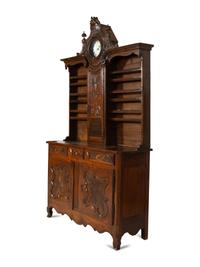 A French Provincial Carved Walnut Clock-Inset Vaissellier