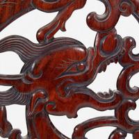 A Chinese carved and pierced huanghuali "dragon" panel, in later hardwood stand 黄花梨镂雕龙纹木板 后配底座 The panel late Ming/Qing dynasty ??????