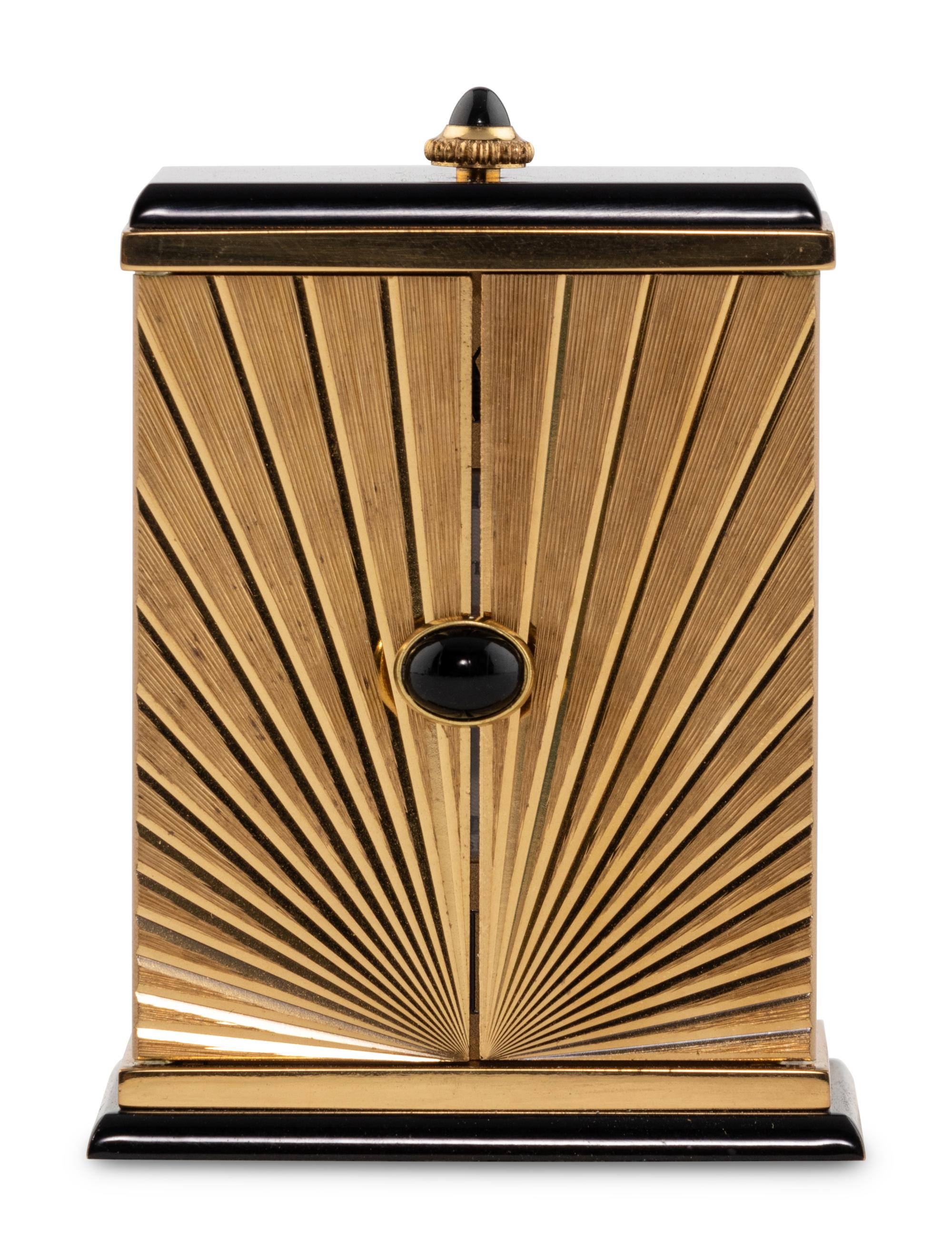 A Cartier Engraved Brass and Onyx Travel Clock