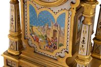 A French Gilt Bronze and Painted Porcelain Clock Garniture