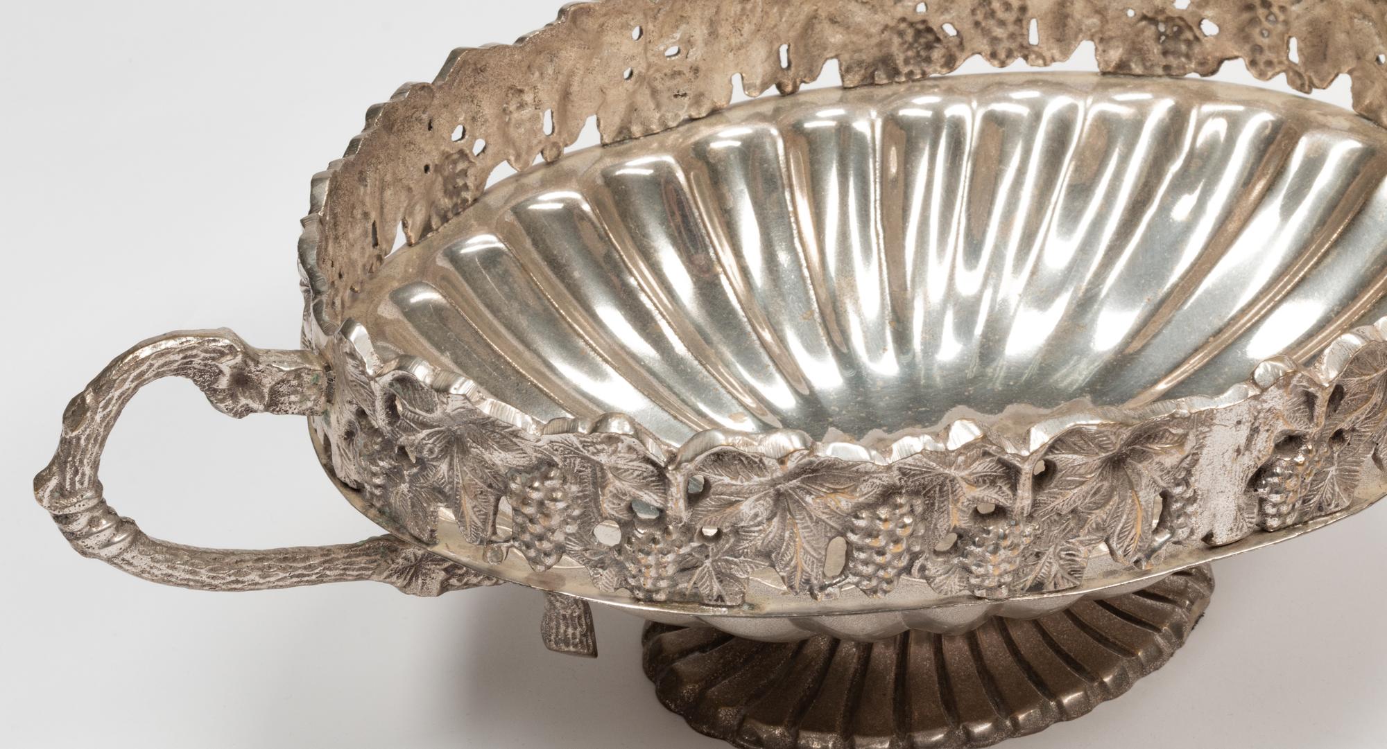 A Set of Four Silver-Plate Handled Dishes