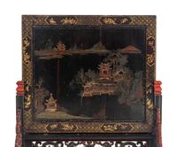 A Chinese Export Painted Table Screen in a Carved Lacquer Stand