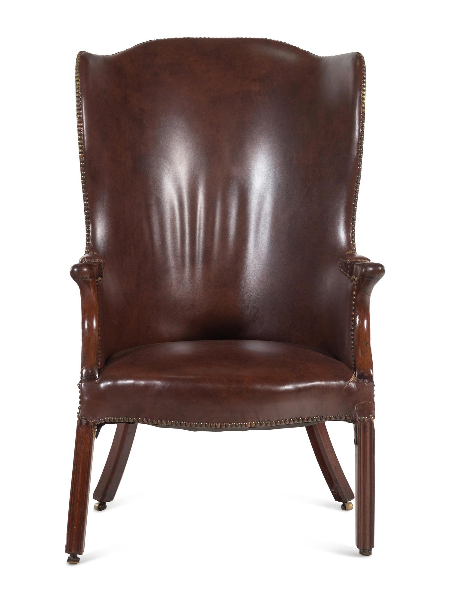 An English Leather Upholstered Mahogany Wingback Armchair