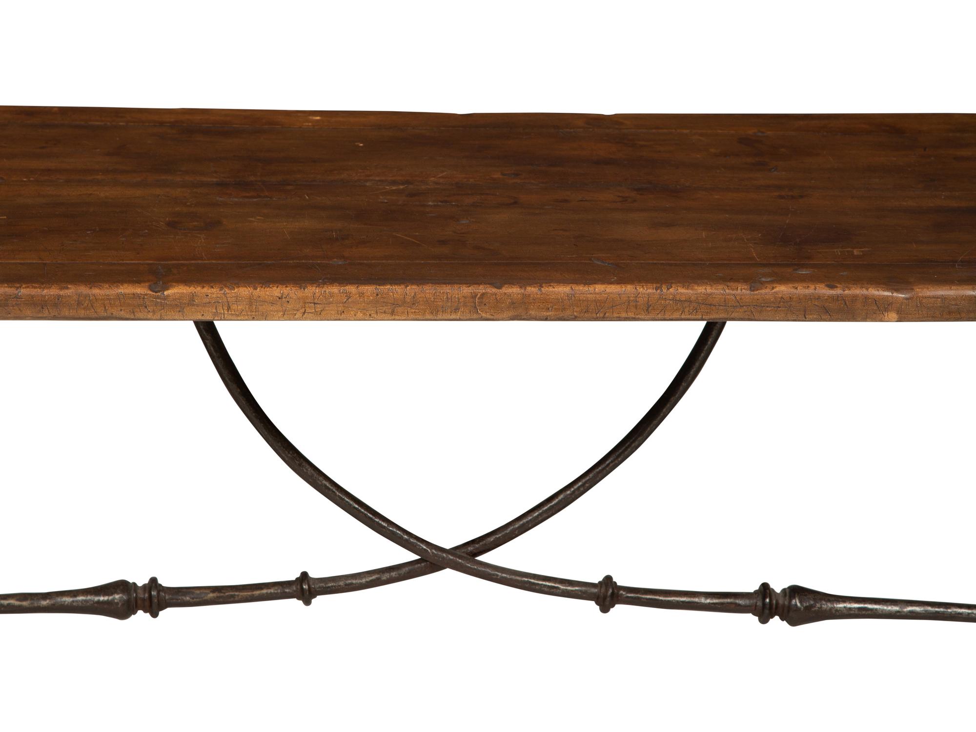 A Spanish Walnut and Wrought Iron Trestle Table