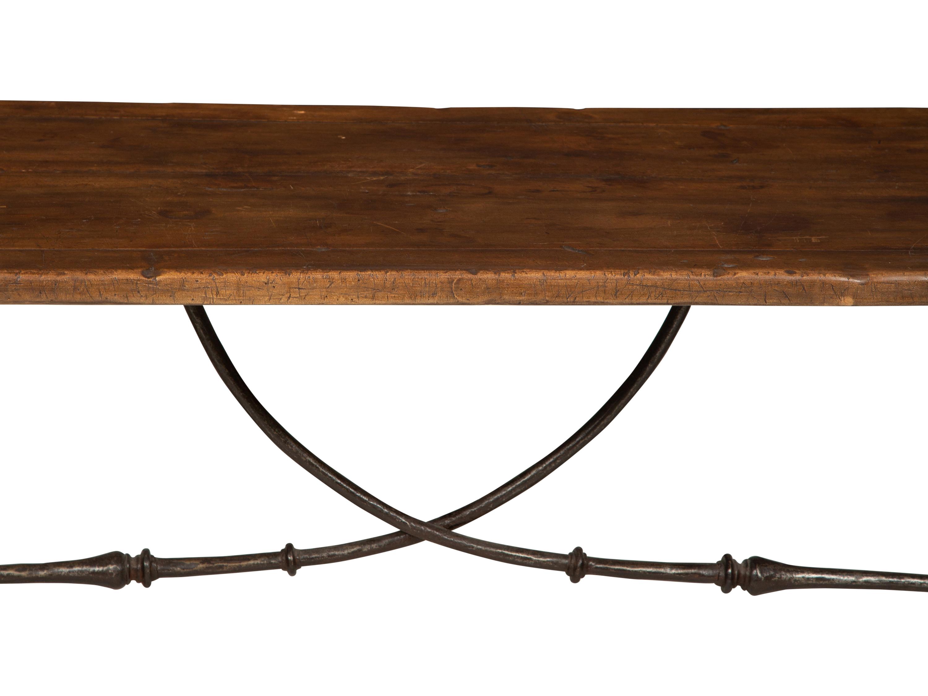 A Spanish Walnut and Wrought Iron Trestle Table